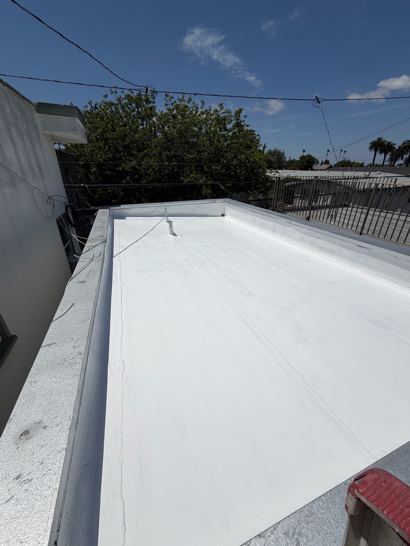 Finished white silicone roof coating on an ADU in Long Beach