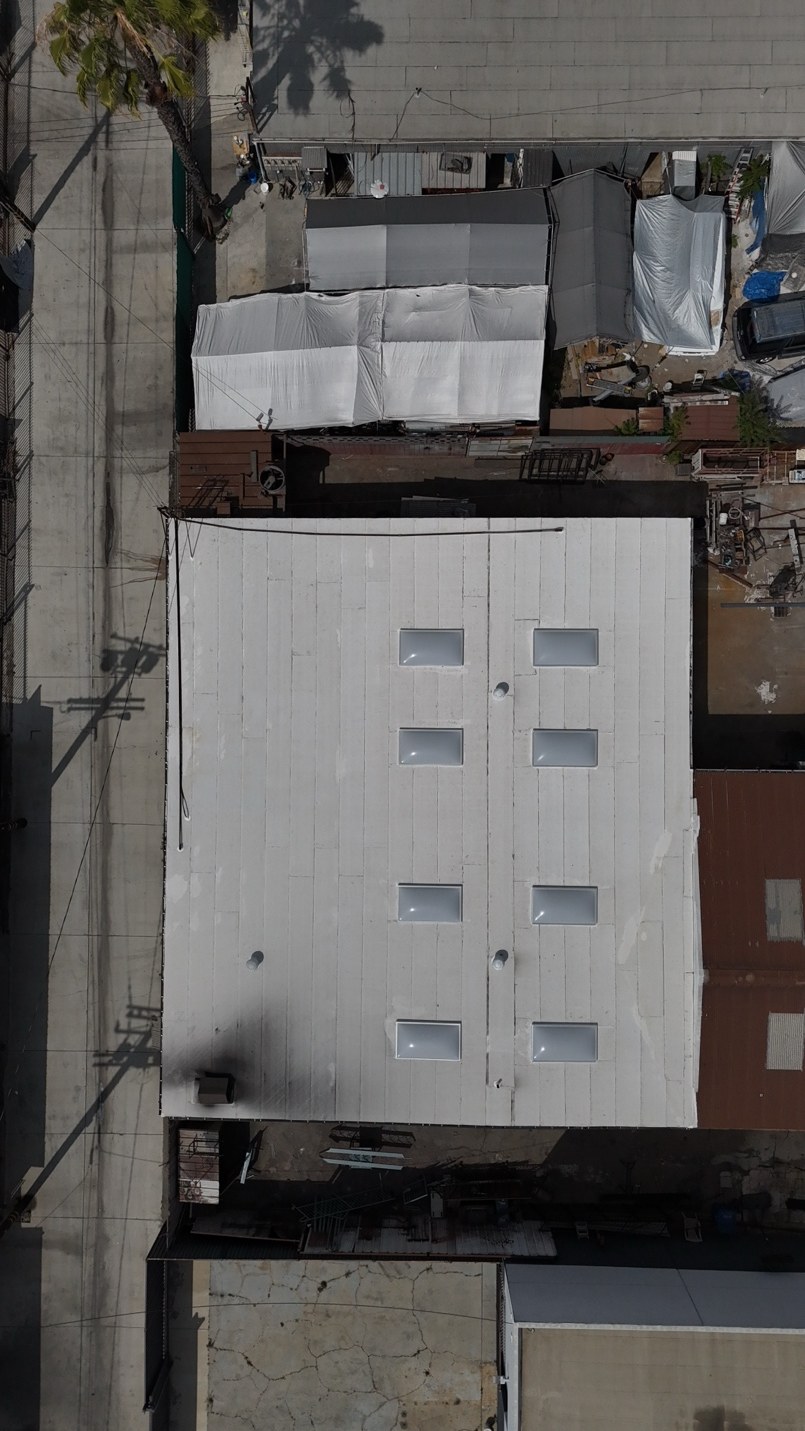Aerial view of a warehouse flat torch roof and skylight installation in Paramount