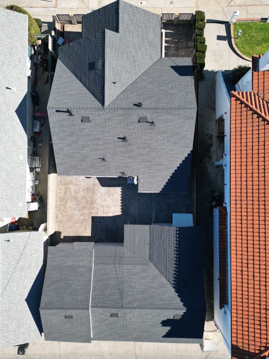 Aerial view of a shingle roof replacement on a single family home and detached garage in San Pedro