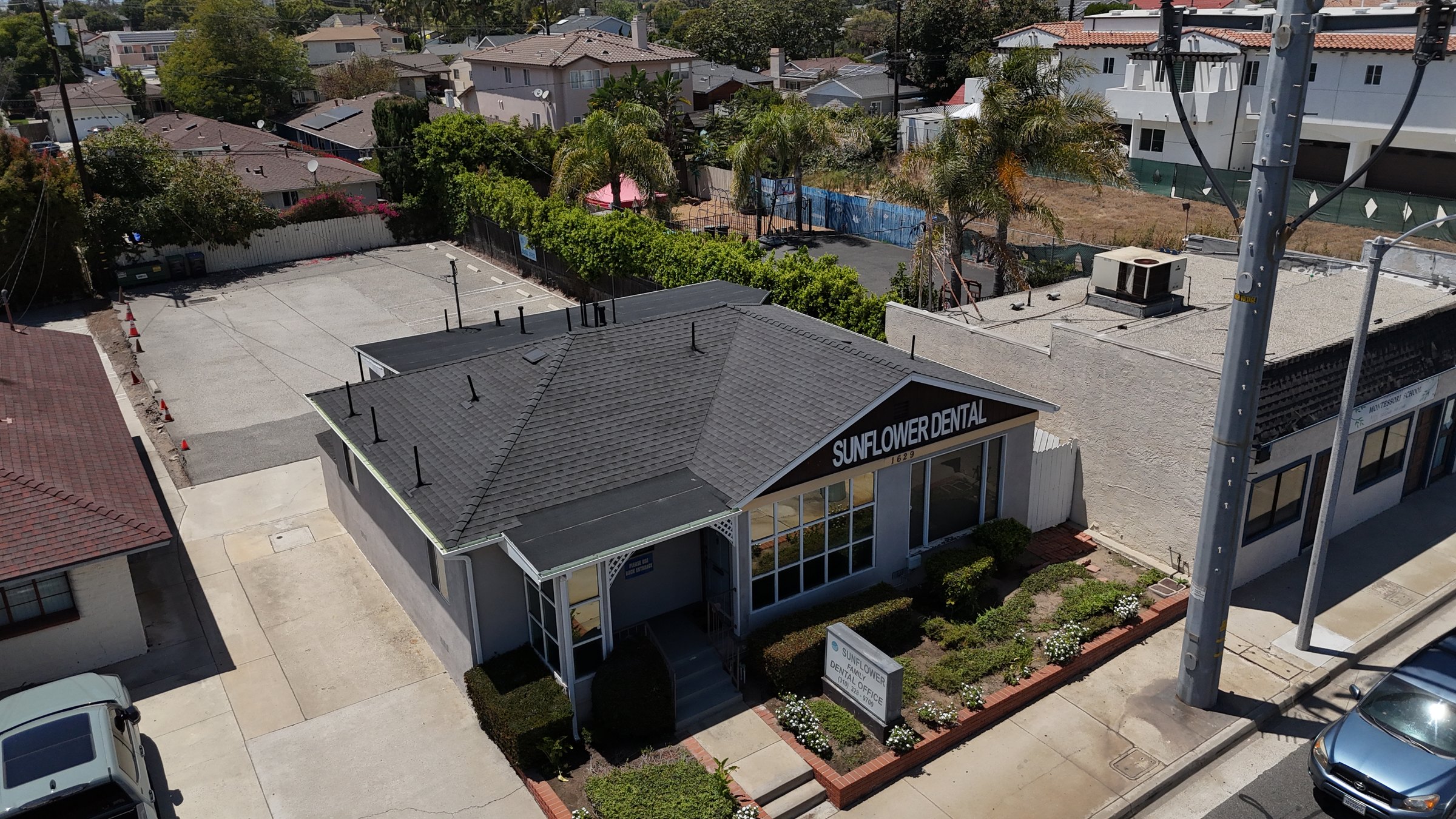 Aerial drone view of the finished shingle roof replacement on a Torrance dental office